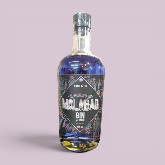 Botella Malabar Aflora 700 ml sobre fondo lila: gin mestizo azul que cambia de color